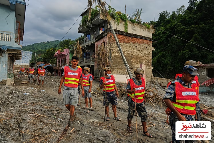 Workers clear debris in the aftermath of a flash flood in the Devighat area of Nuwakot district in Nepal, 28 August, 2026